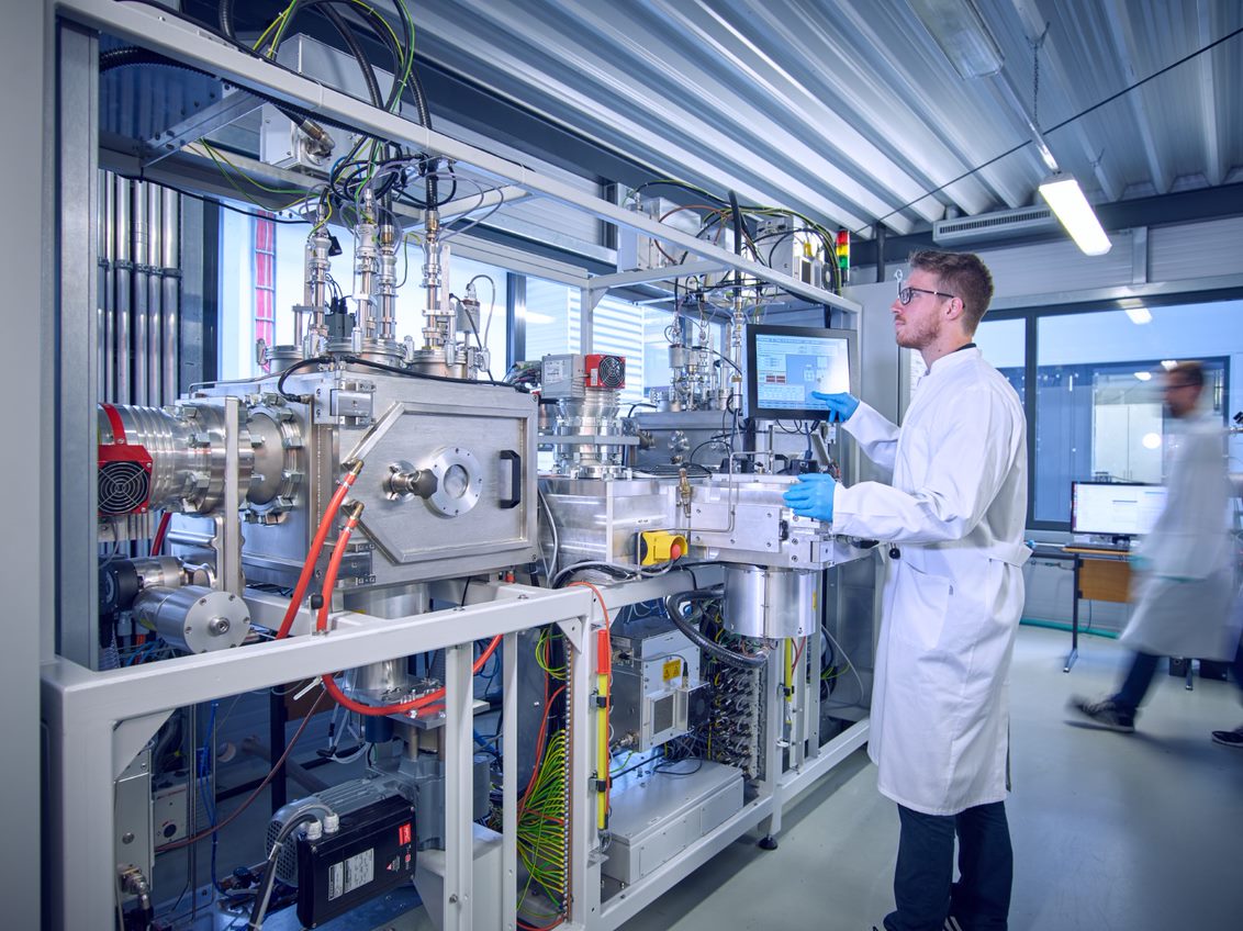 Engineer operating dual-use research equipment in a laboratory