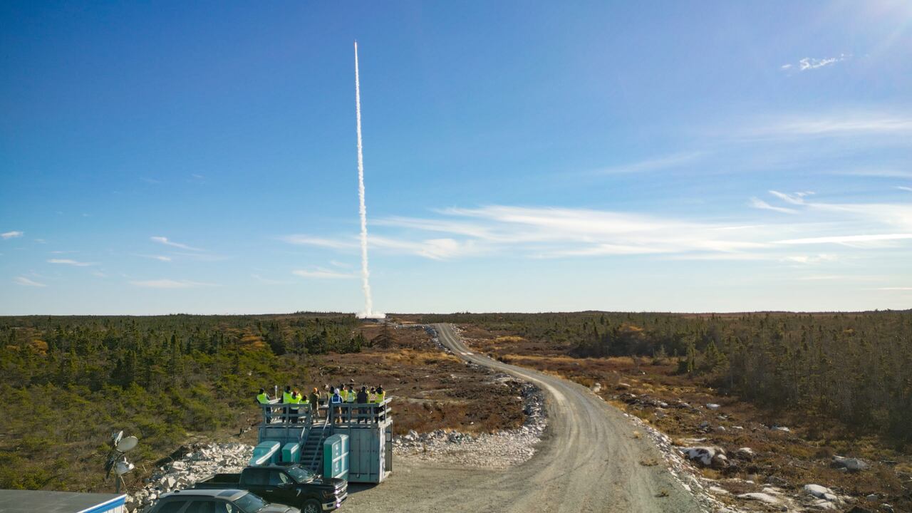 Rocket launching from a Canadian launch site as observers watch